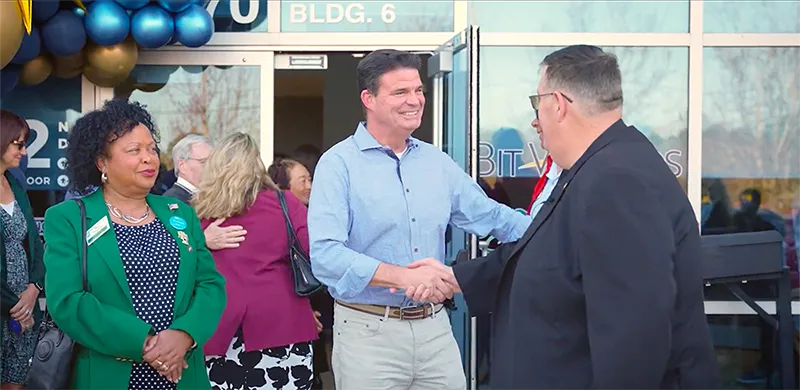 Chamber member shaking hands with Bit-Wizard’s CEO